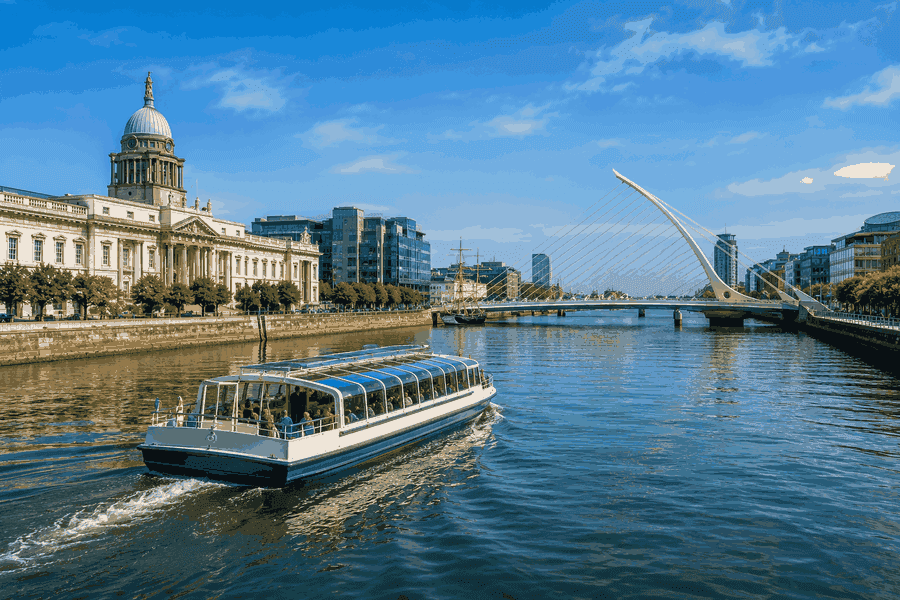 Dublin sightseeing boat cruising along the River Liffey with the Custom House and Samuel Beckett Bridge in view.